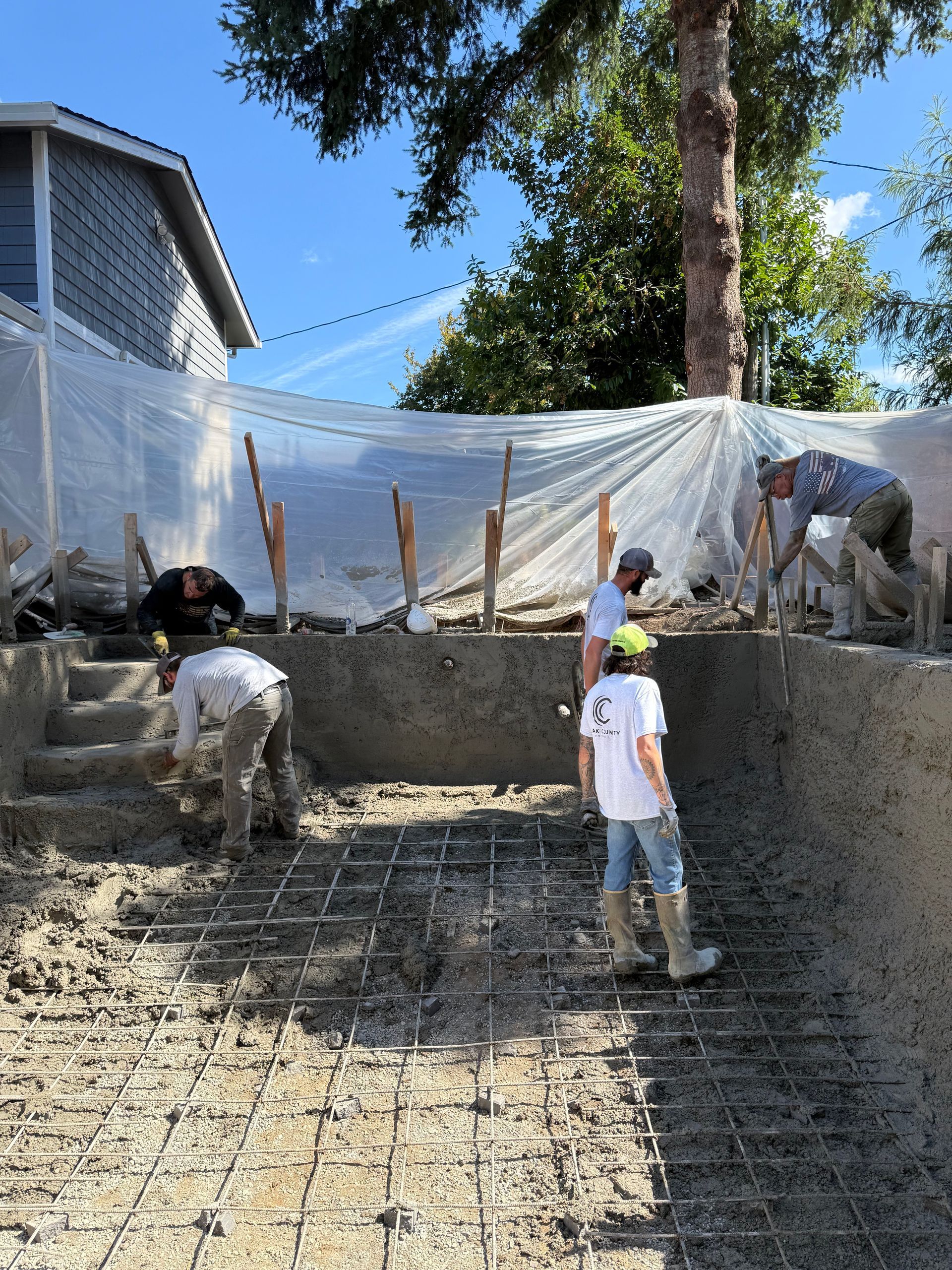 A large empty room with concrete floors and columns in a building under construction.