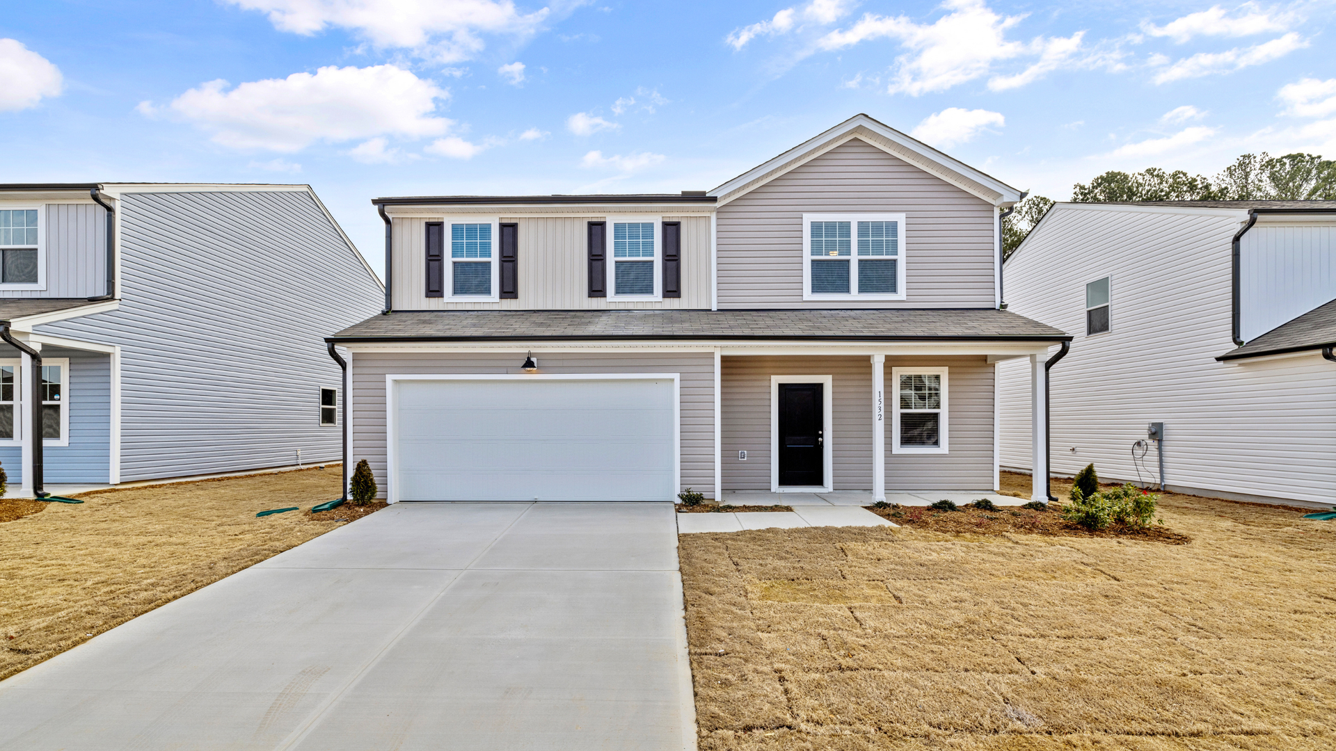 Newly installed concrete driveway in Clark County in front of modern residential home