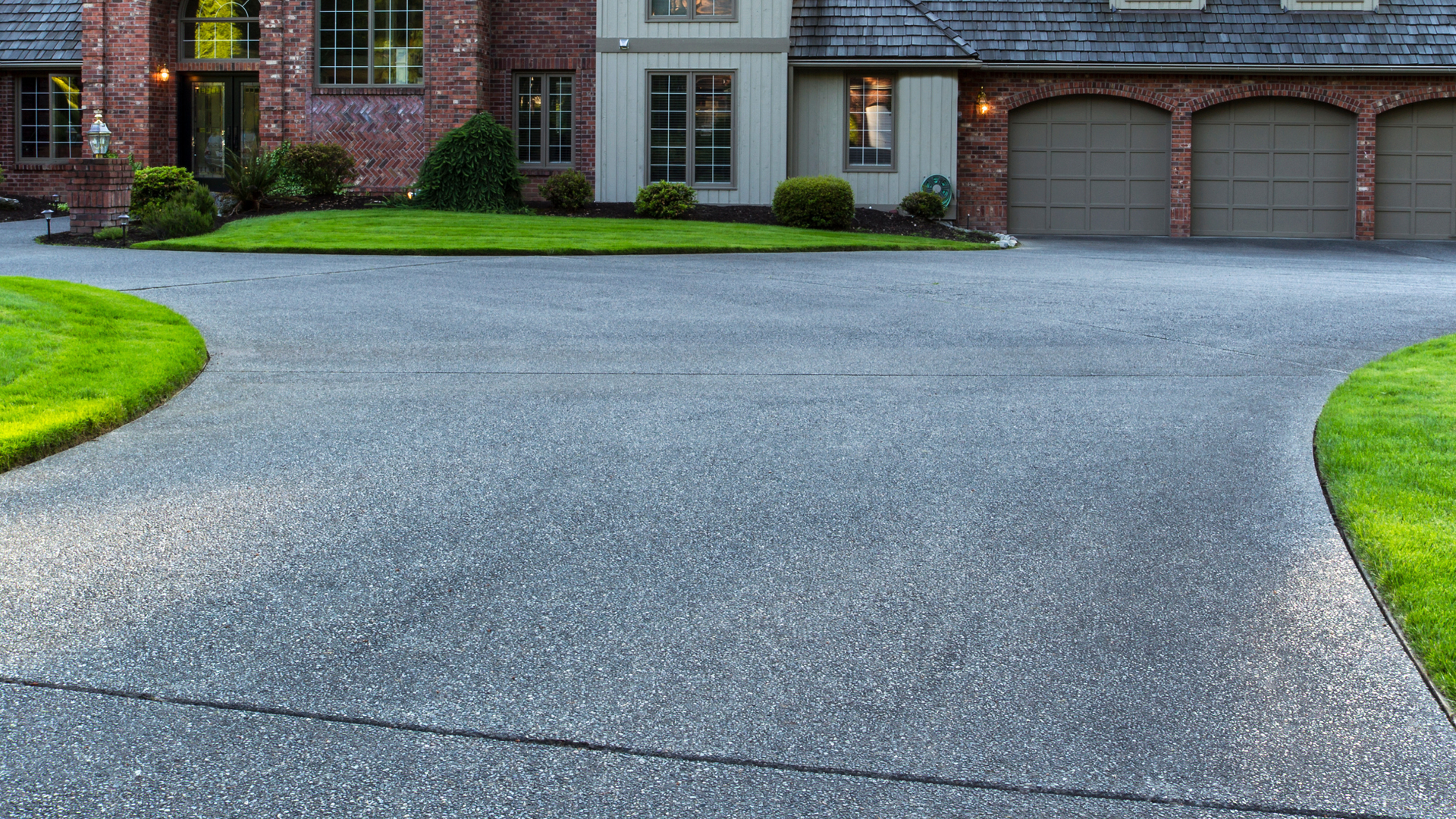 Exposed aggregate concrete driveway with curved layout in residential Clark County property