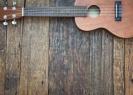 Guitar placed on wooden surface
