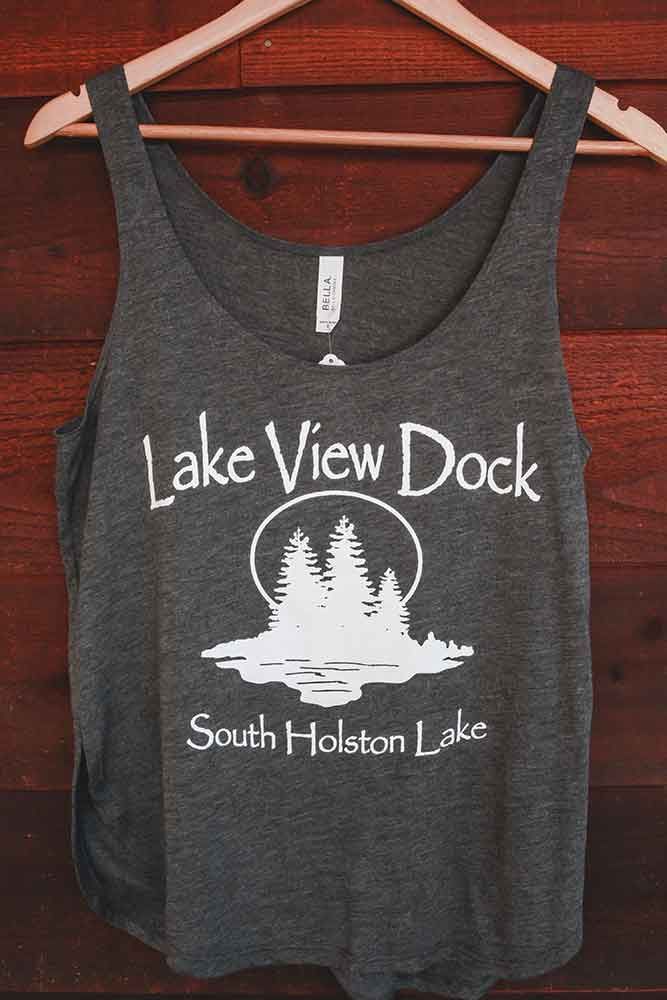 A tank top that says lake view dock south holston lake is hanging on a wooden hanger.