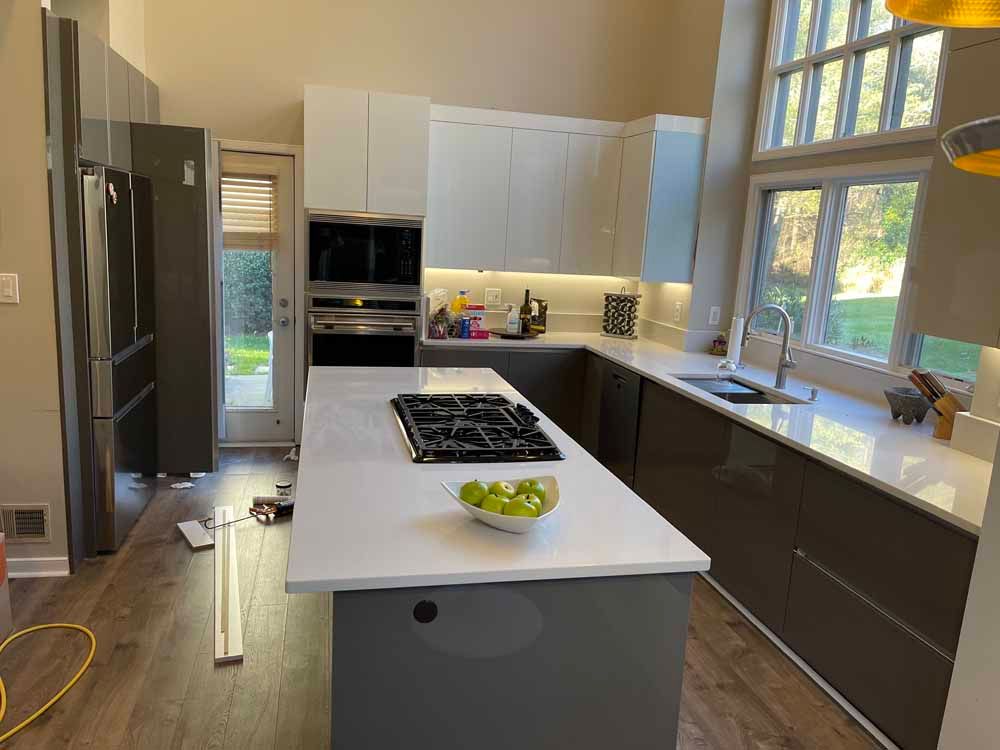 A kitchen with a large island and a stove top oven.