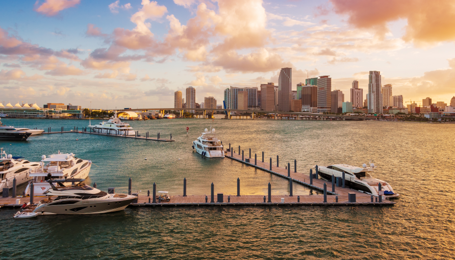 A dock and boats in downtown Miami during sunset. 
