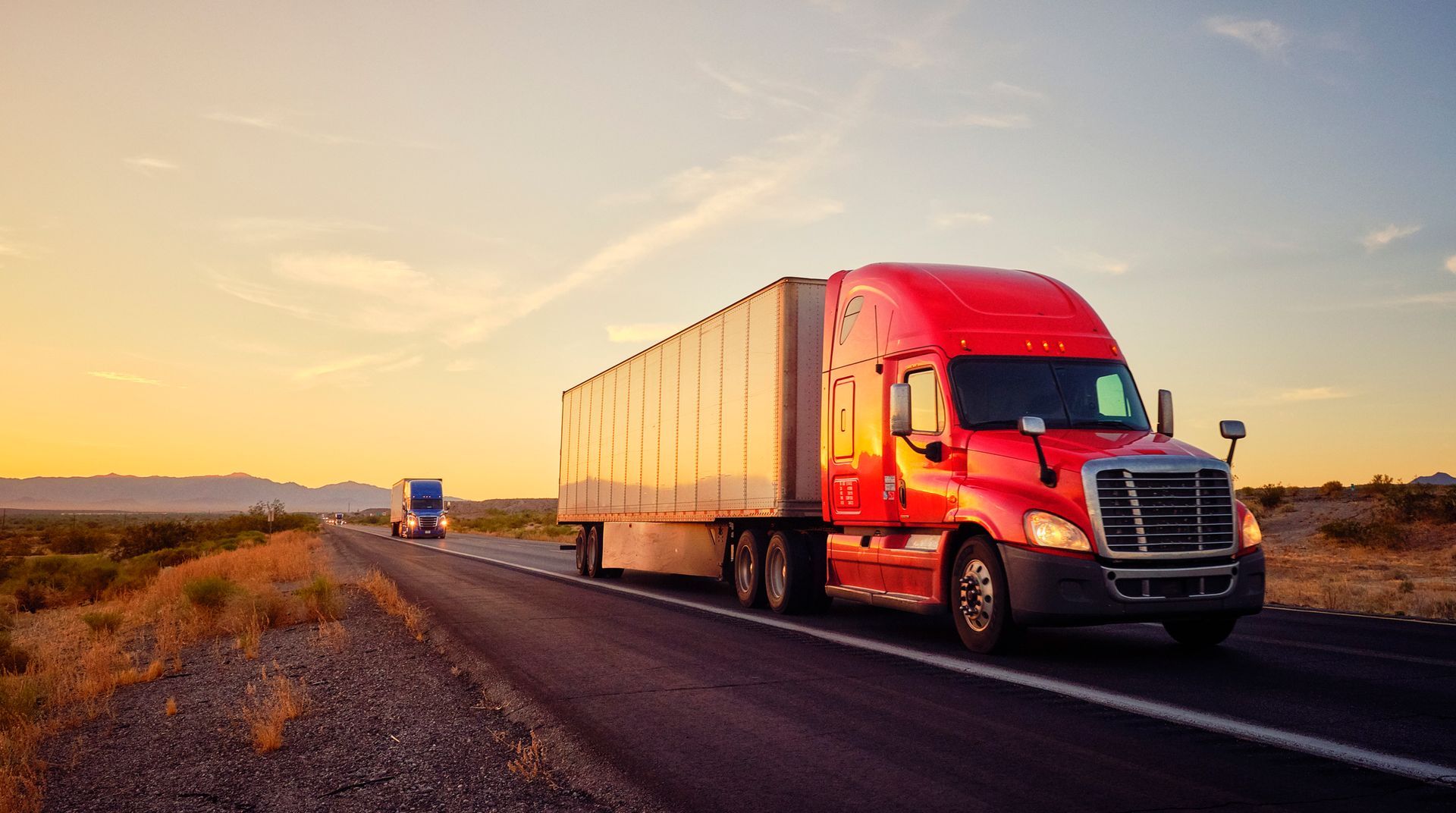 Long-haul semi-trailer truck on a rural interstate highway.