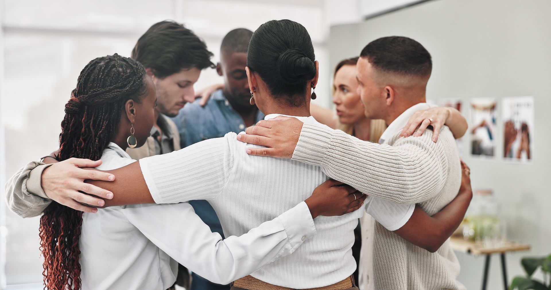 A group of people are hugging each other in a circle.