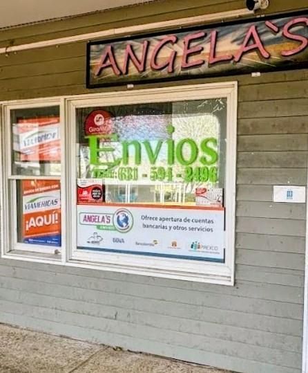Tan commercial building with a blue sign that reads 