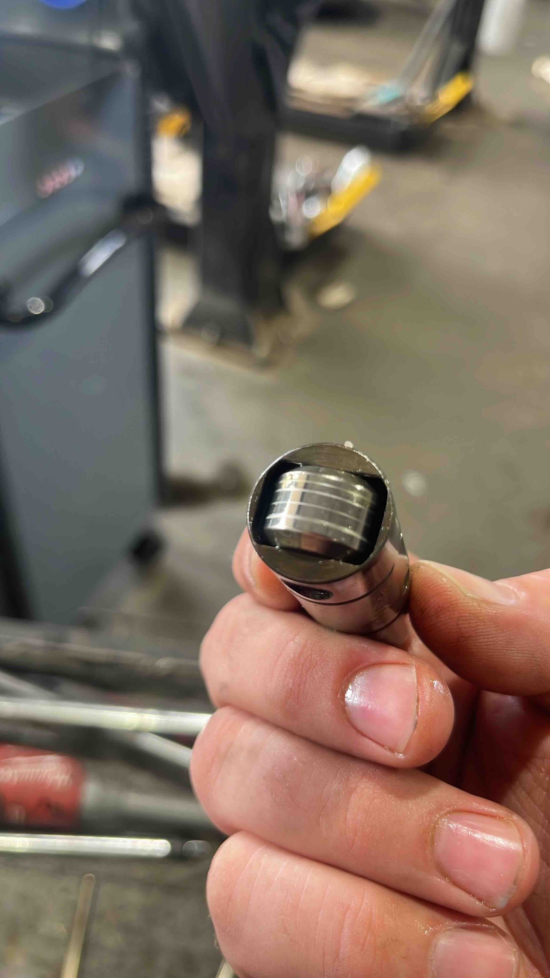 Technician Holding Automotive Sensor Component For Inspection | Sumners Automotive