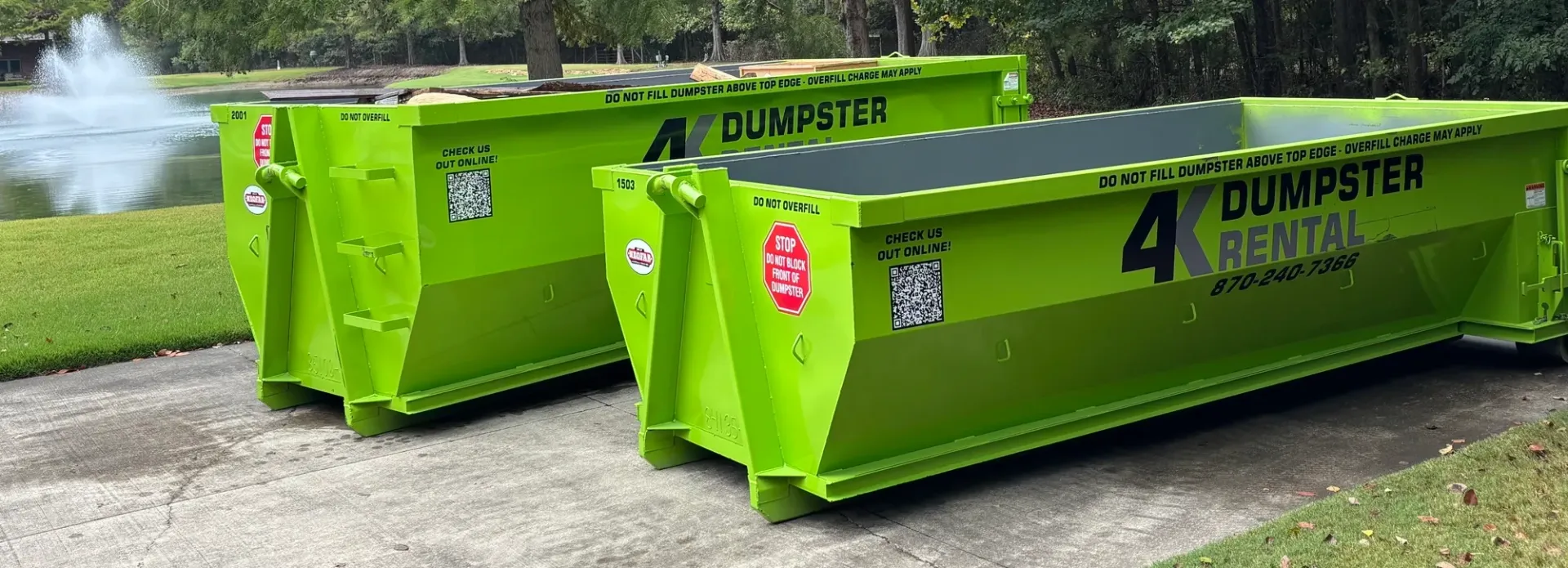 A dumpster is parked in the snow in front of a house.