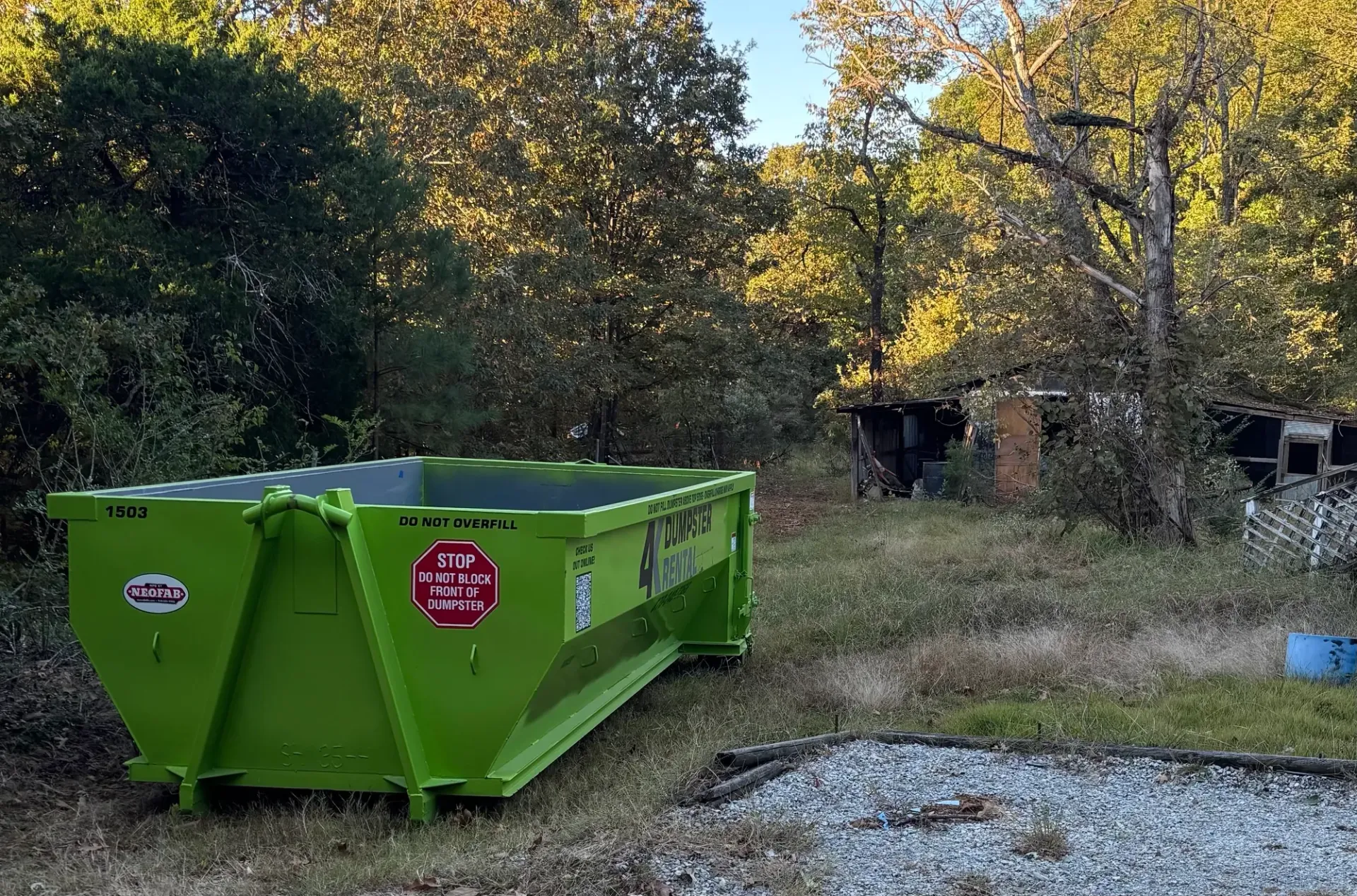 A red suv is parked in the snow in front of a house.