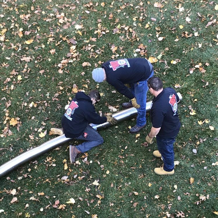 Three Men Fixing Chimney Liner — Wayne, NJ — Chimney Pros Three Men Fixing Chimney Liner — Wayne, NJ — Chimney Pros