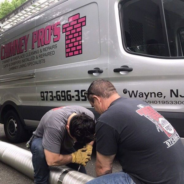 Workers Repairing Chimney Liner — Wayne, NJ — Chimney Pros