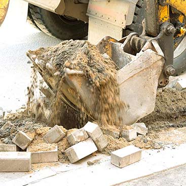 Excavator on the street asphalt - Excavation & demolition service in Omaha, NE