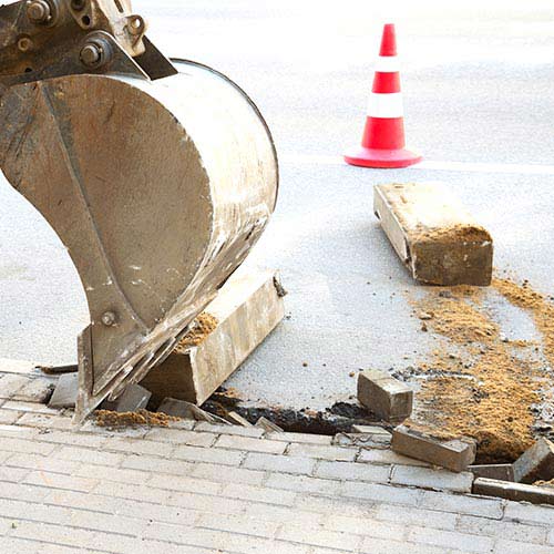 Excavator on the street asphalt road repair - Excavation & demolition service in Omaha, NE