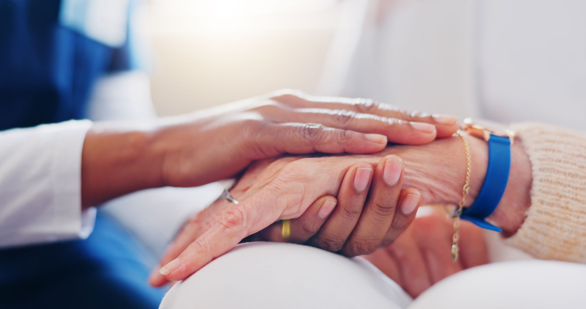 A close up of a person holding another person 's hand.