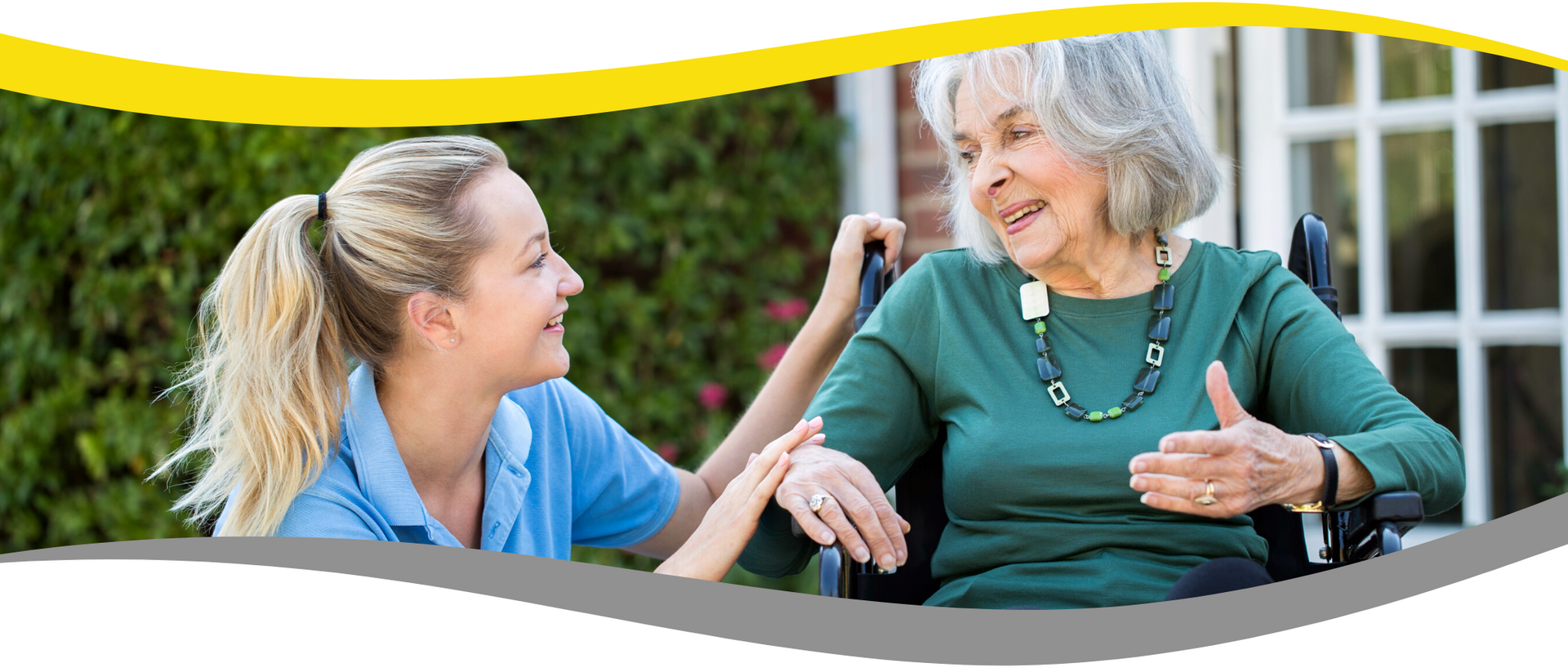 A nurse is helping an elderly woman in a wheelchair.