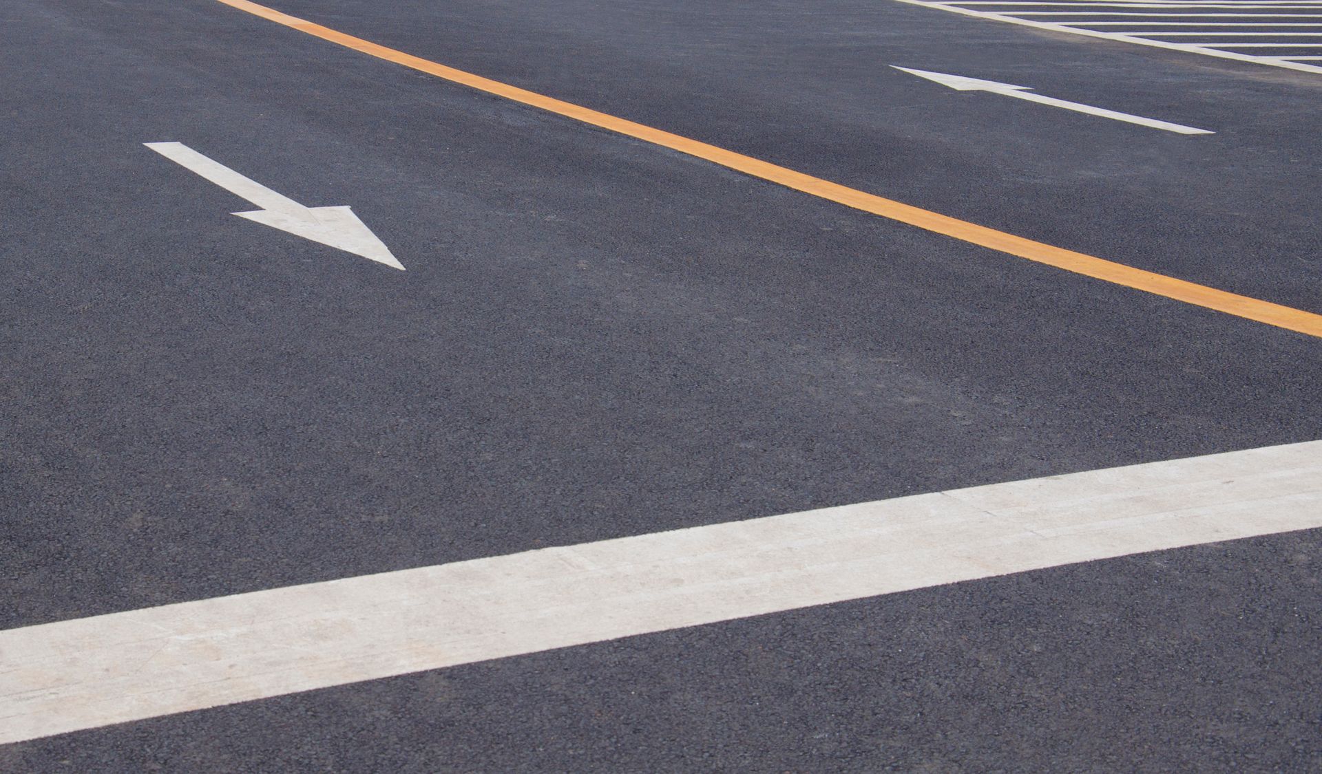 A white arrow is painted on the side of a road