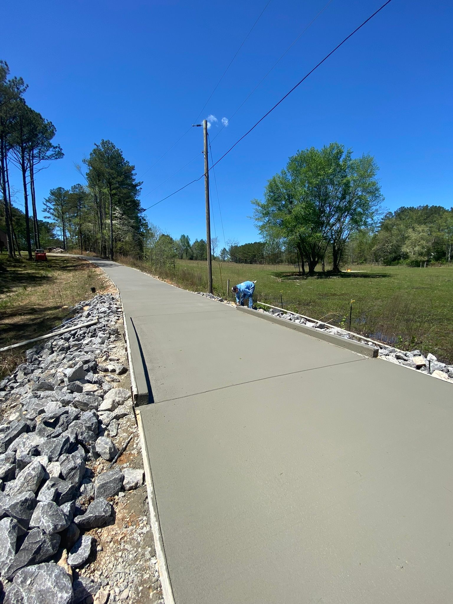 A group of construction workers are pouring concrete on a construction site.