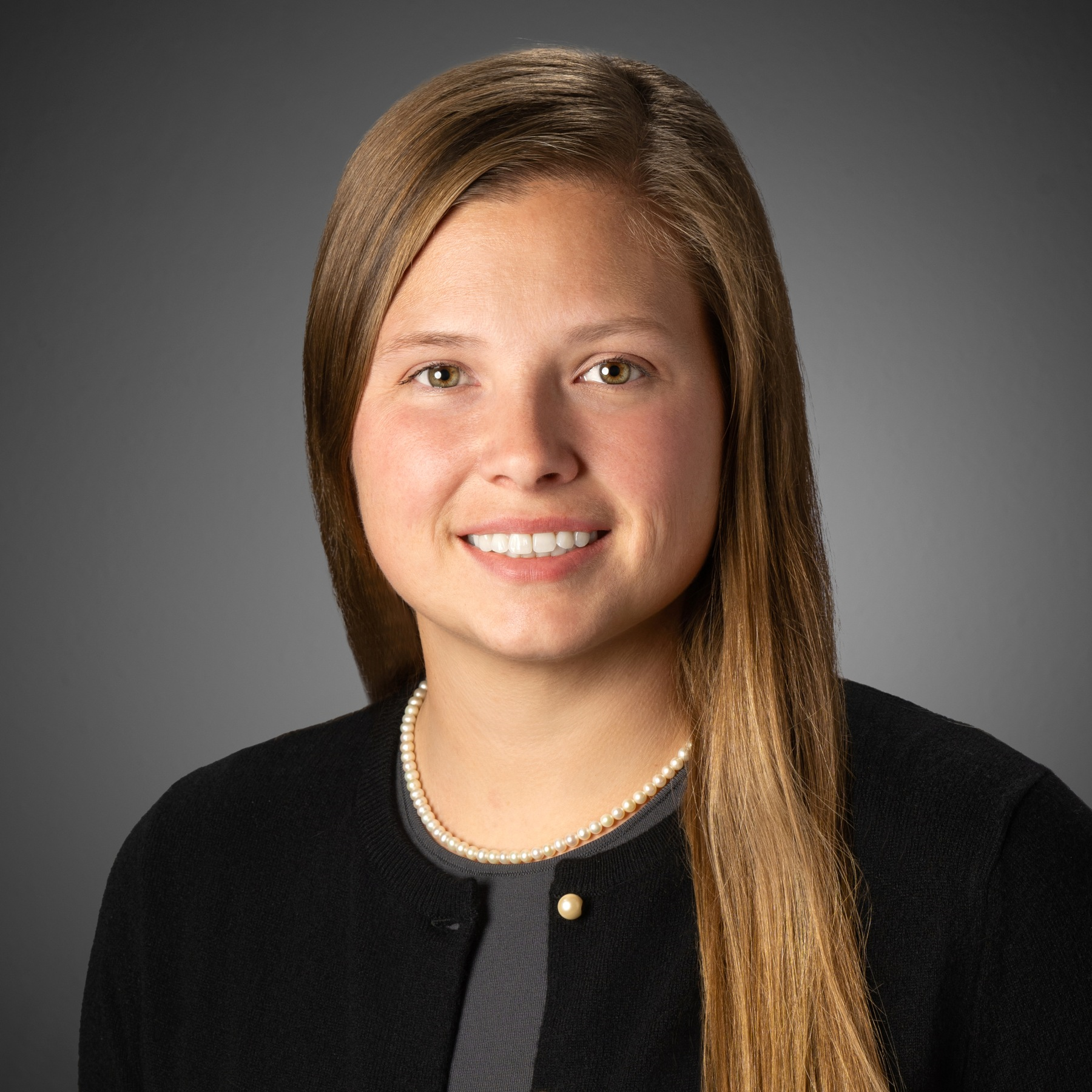 A man in a suit and tie is smiling for the camera.