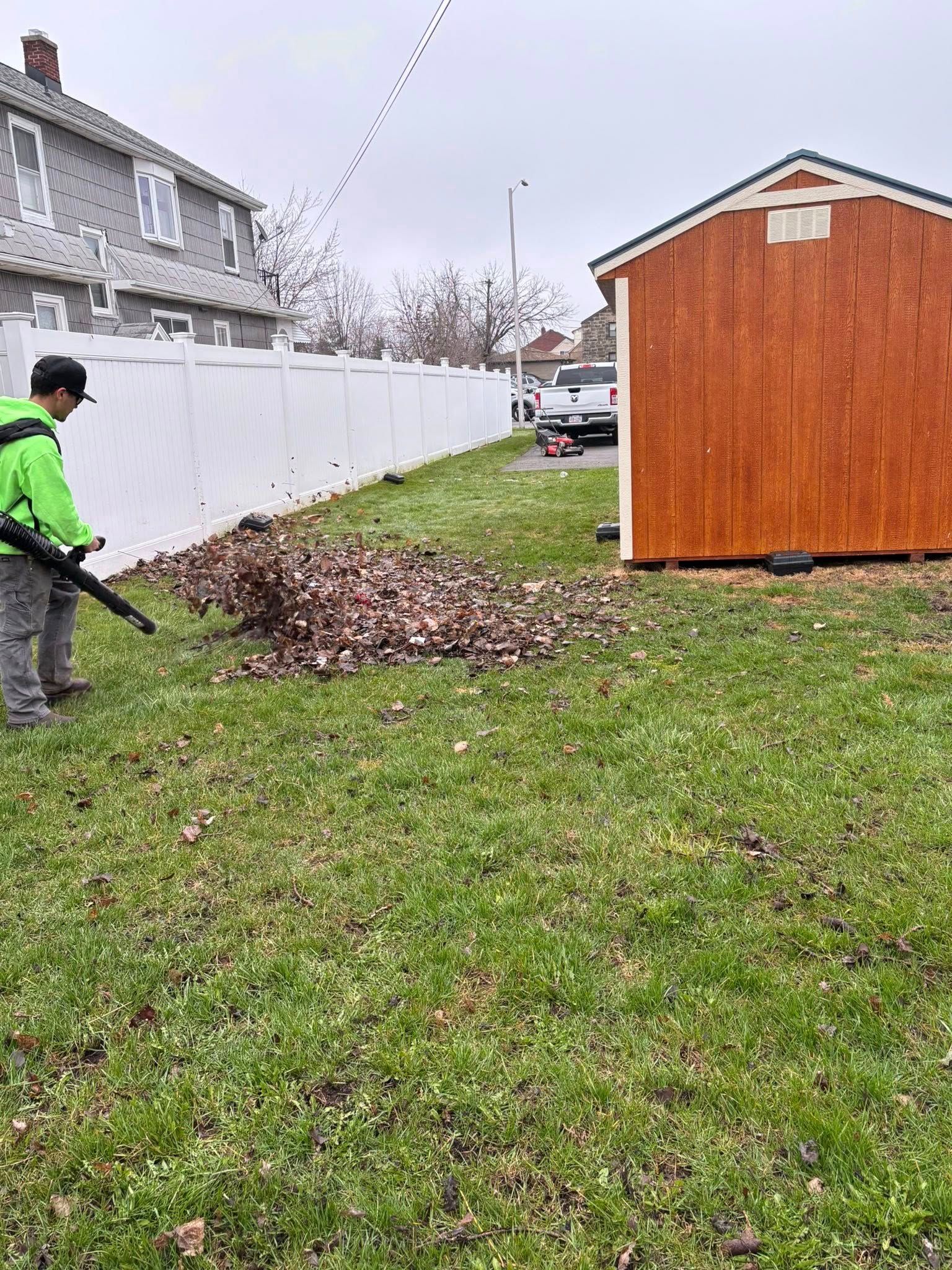 Green lawn with curving stone path leading to stairs. Stone wall with plants and greenery.