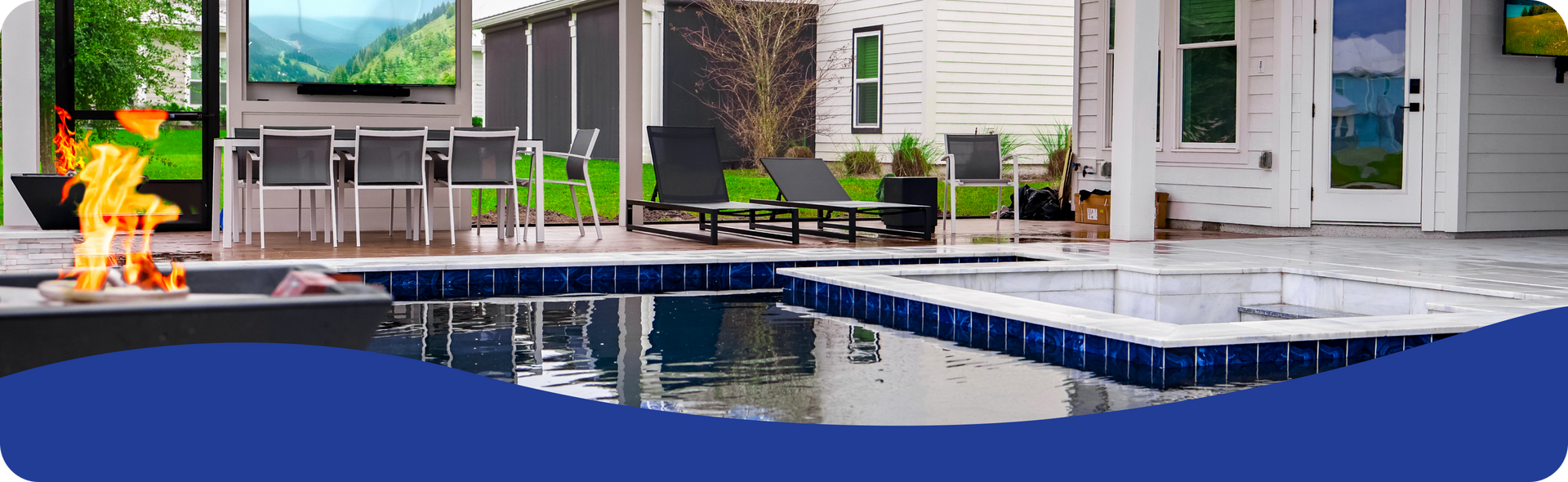 Luxury backyard patio with a pool, hot tub, fire pit, outdoor dining, and TV, set against a house.