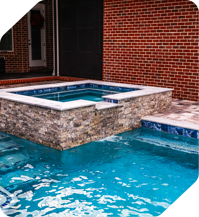 Luxury home with pool; white exterior, balconies, fountains, and fire pit on a sunny day.