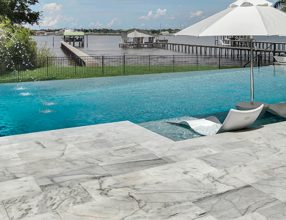 Modern house with pool, lawn, and sky; two-story, white with balcony.