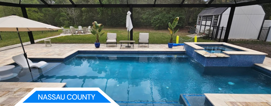Swimming pool with blue water and surrounding patio. Nassau County.