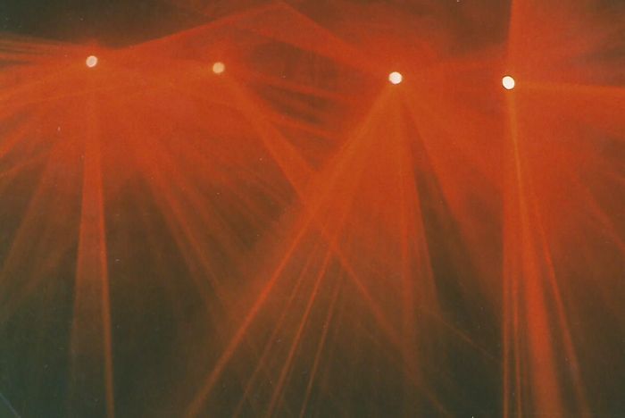 red laser beams through smoke filled dance floor