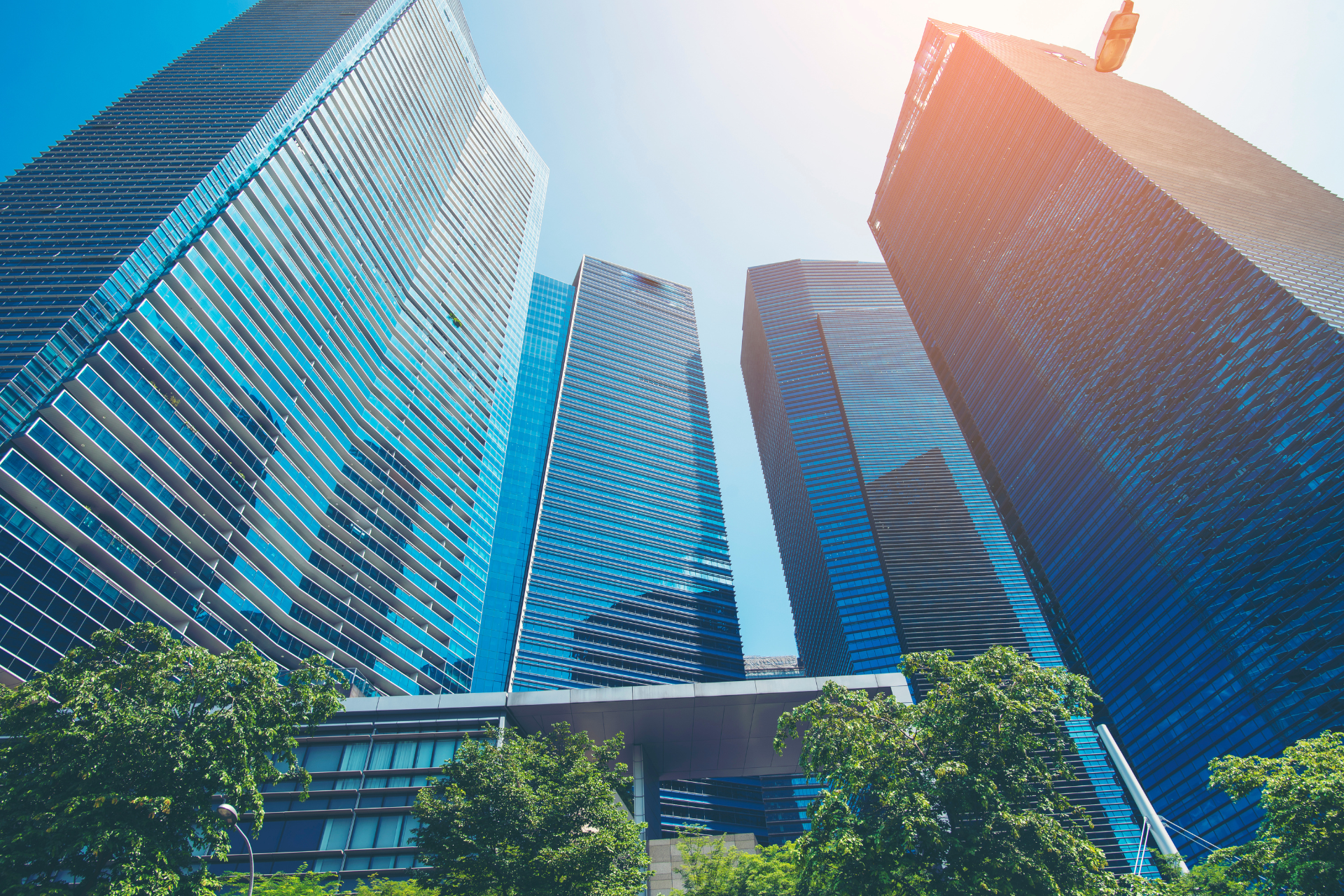 A group of tall buildings are sitting next to each other in a city.