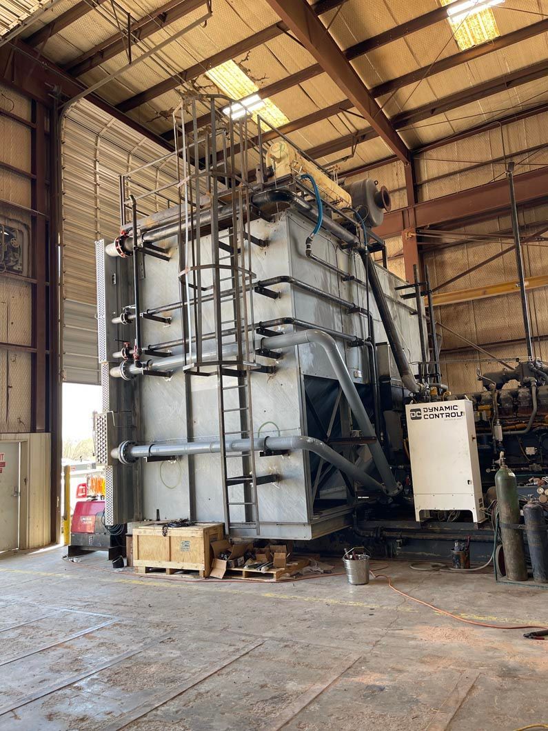 A large metal structure is sitting inside of a building.