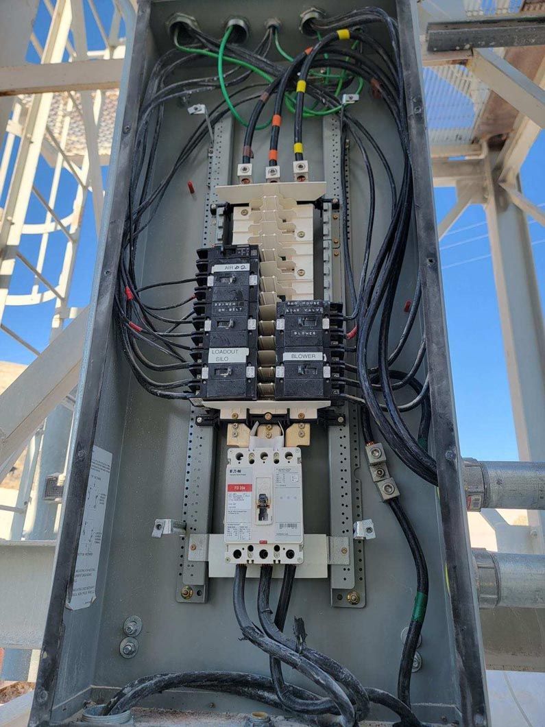 A large electrical box with a lot of wires coming out of it.