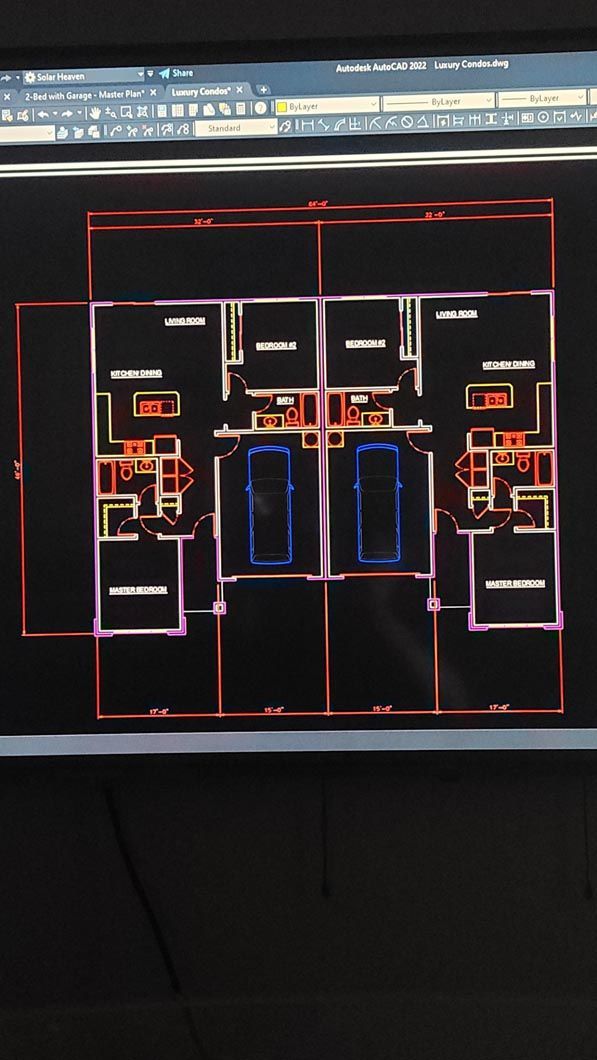 A computer screen shows a floor plan of a house