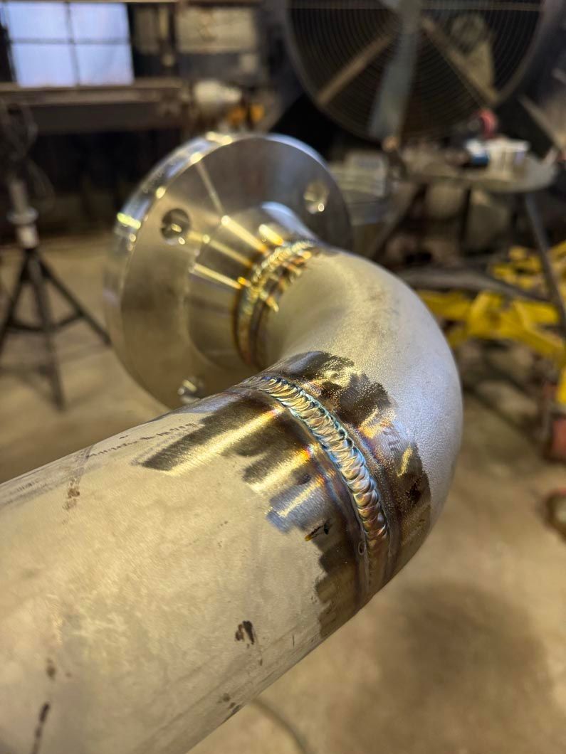 A close up of a metal pipe with a flange on it.