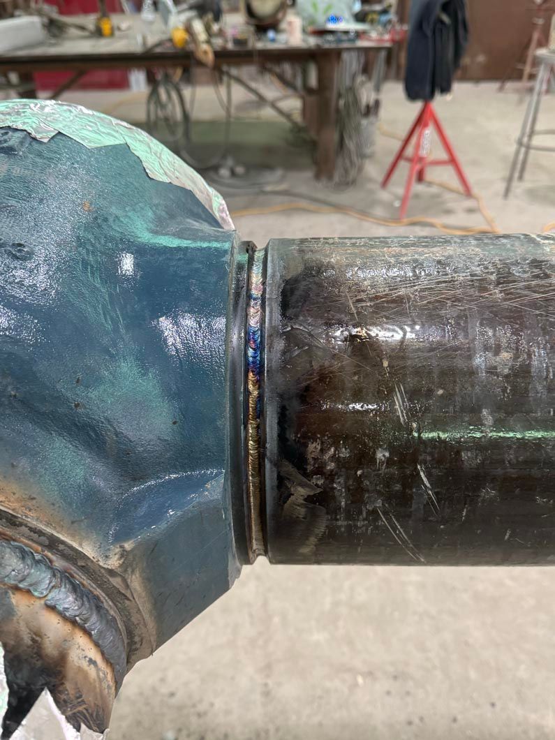 A close up of a metal pipe in a workshop.