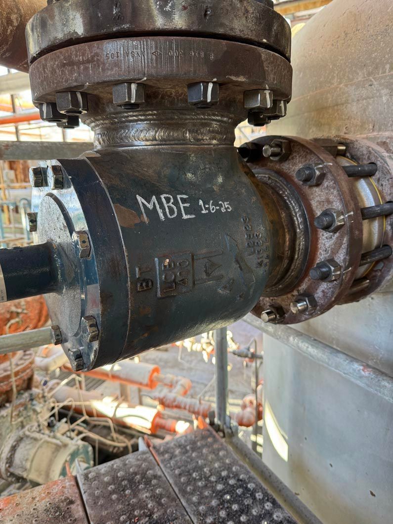A close up of a metal pipe with a valve on it.