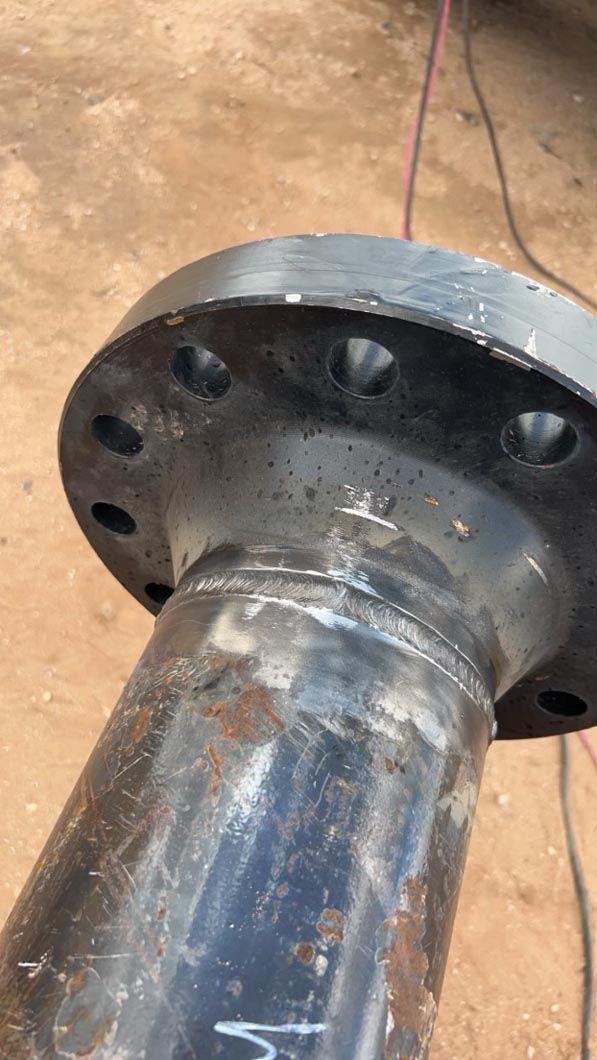 A close up of a metal pipe with a flange on it.