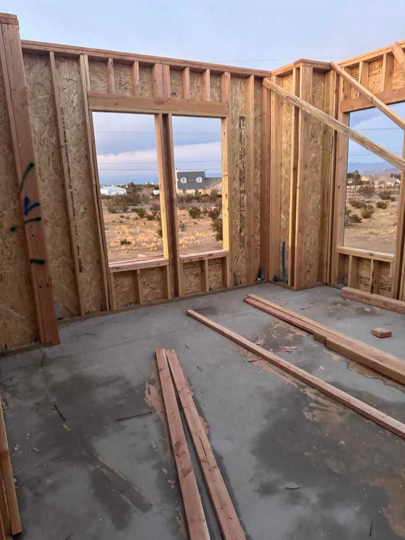 A room in a house that is being built with wooden beams.