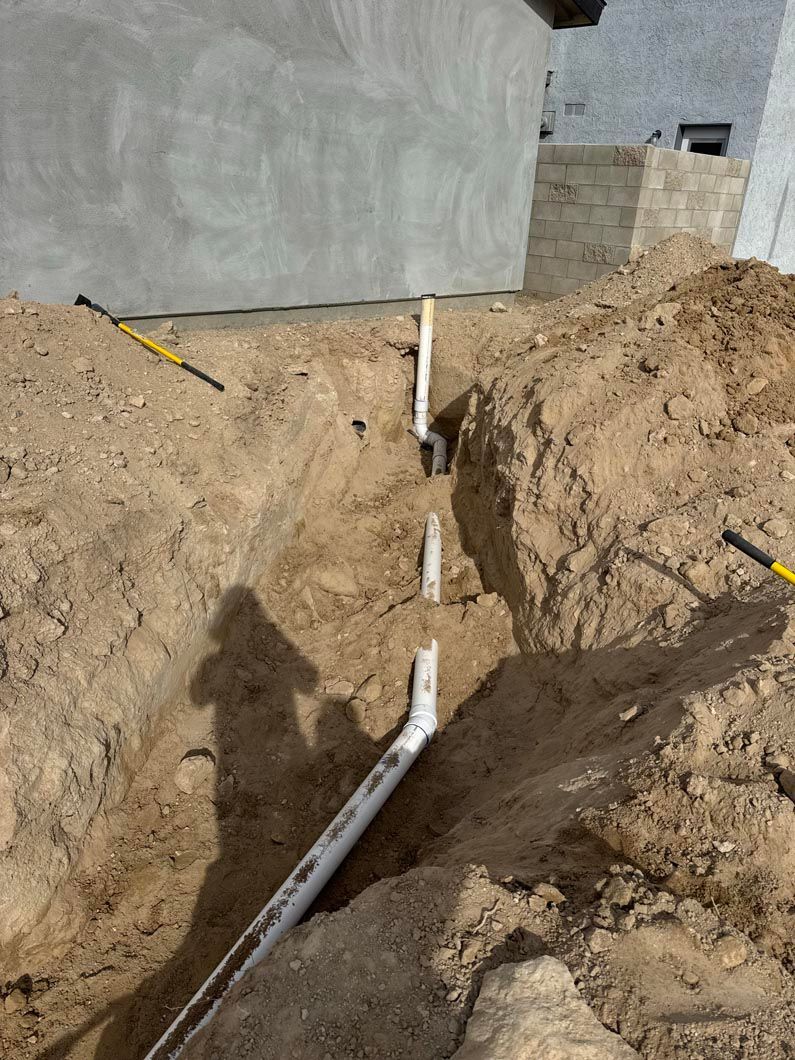 A pipe is being installed in a hole in the ground.
