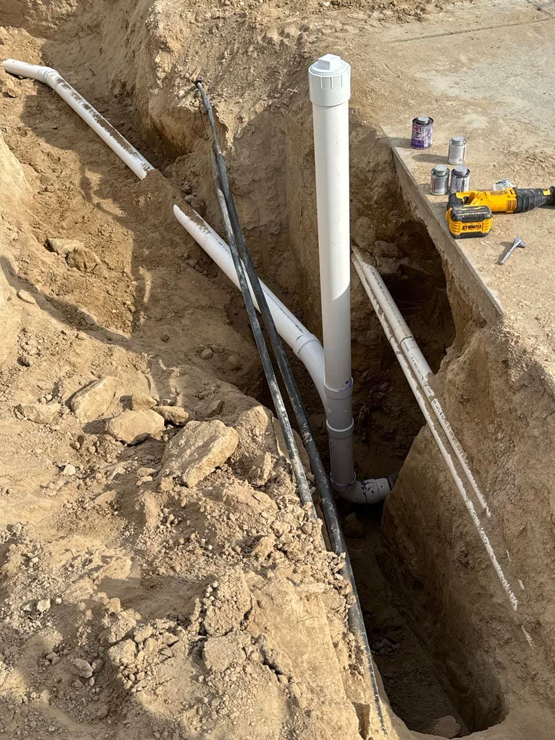 A pipe is being installed in a hole in the ground.
