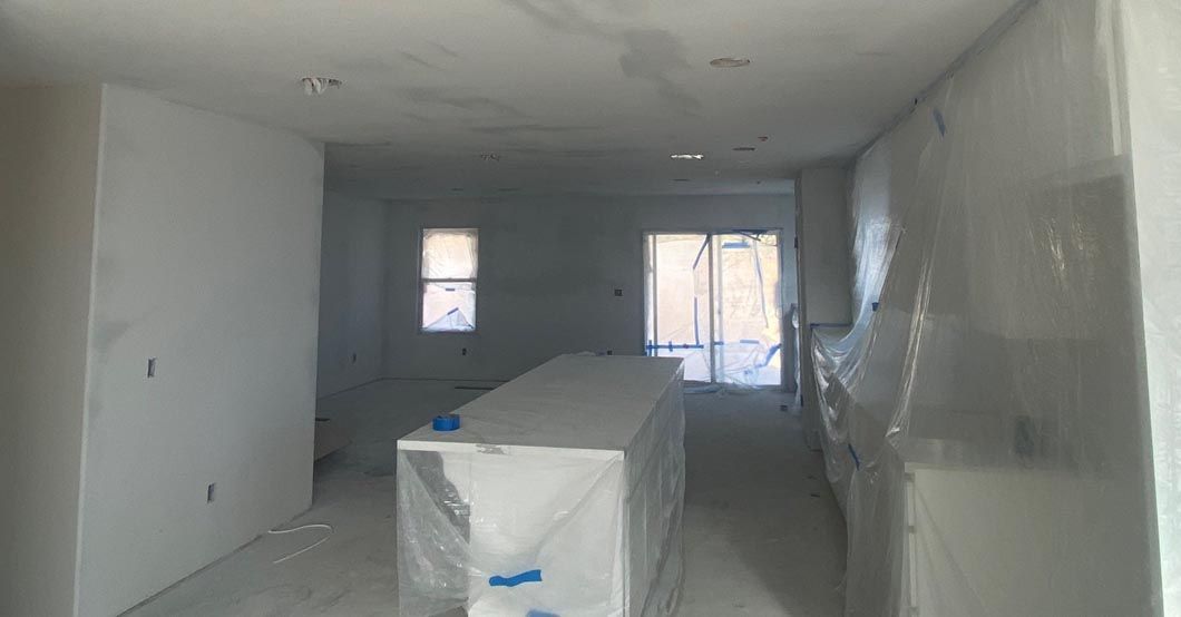 An empty room with a large island in the middle of it.