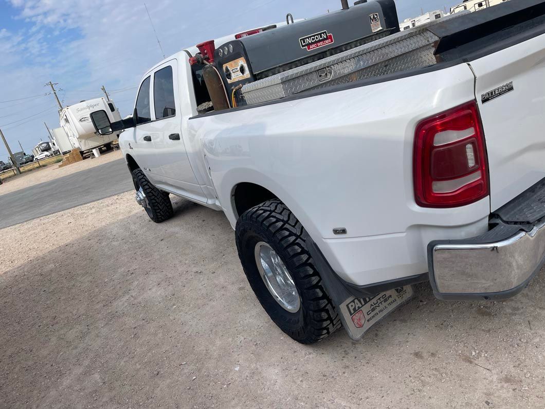 A white truck is parked on the side of the road.