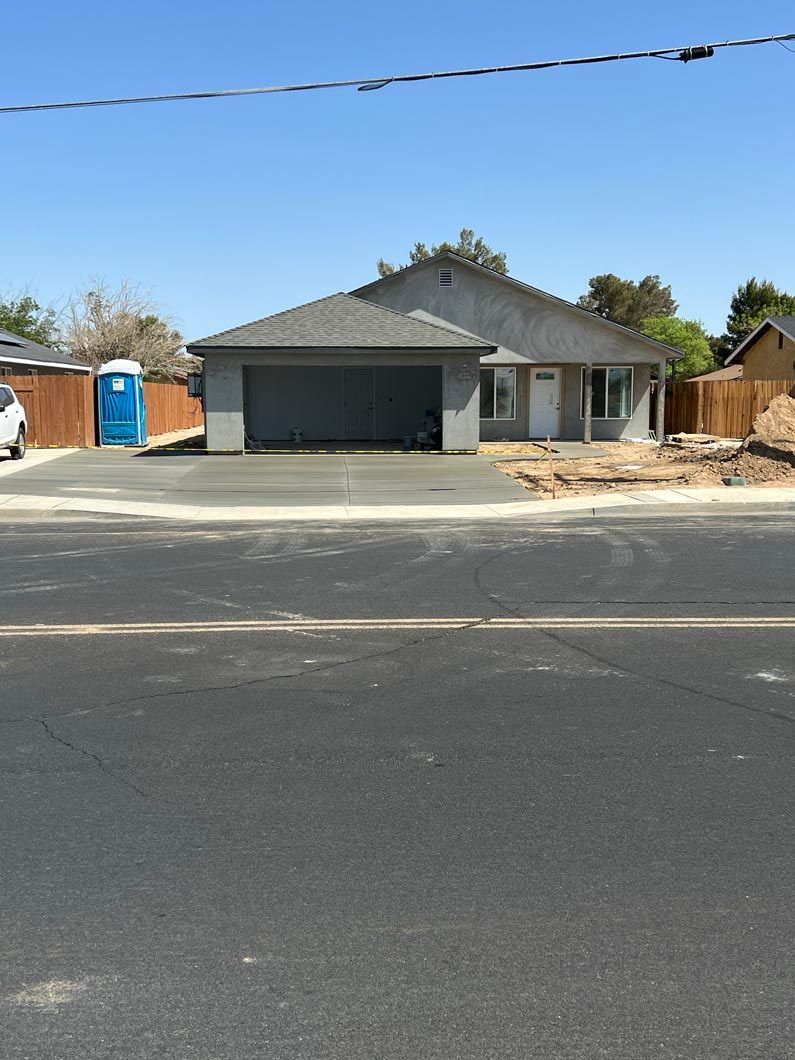 A house with a blue portable toilet in front of it