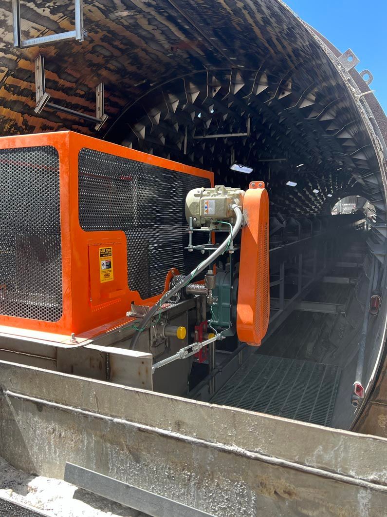 A large orange machine is sitting inside of a building.