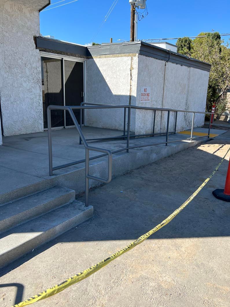 A building with stairs and a railing on the side of it.