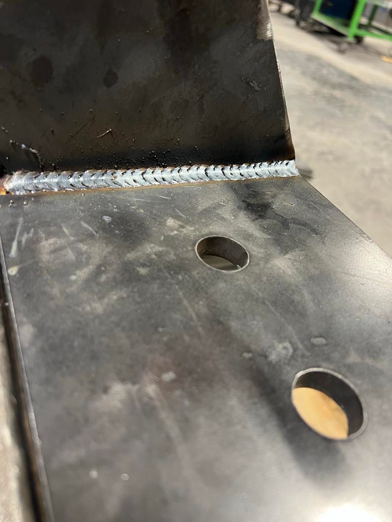 A close up of a piece of metal with a hole in it.