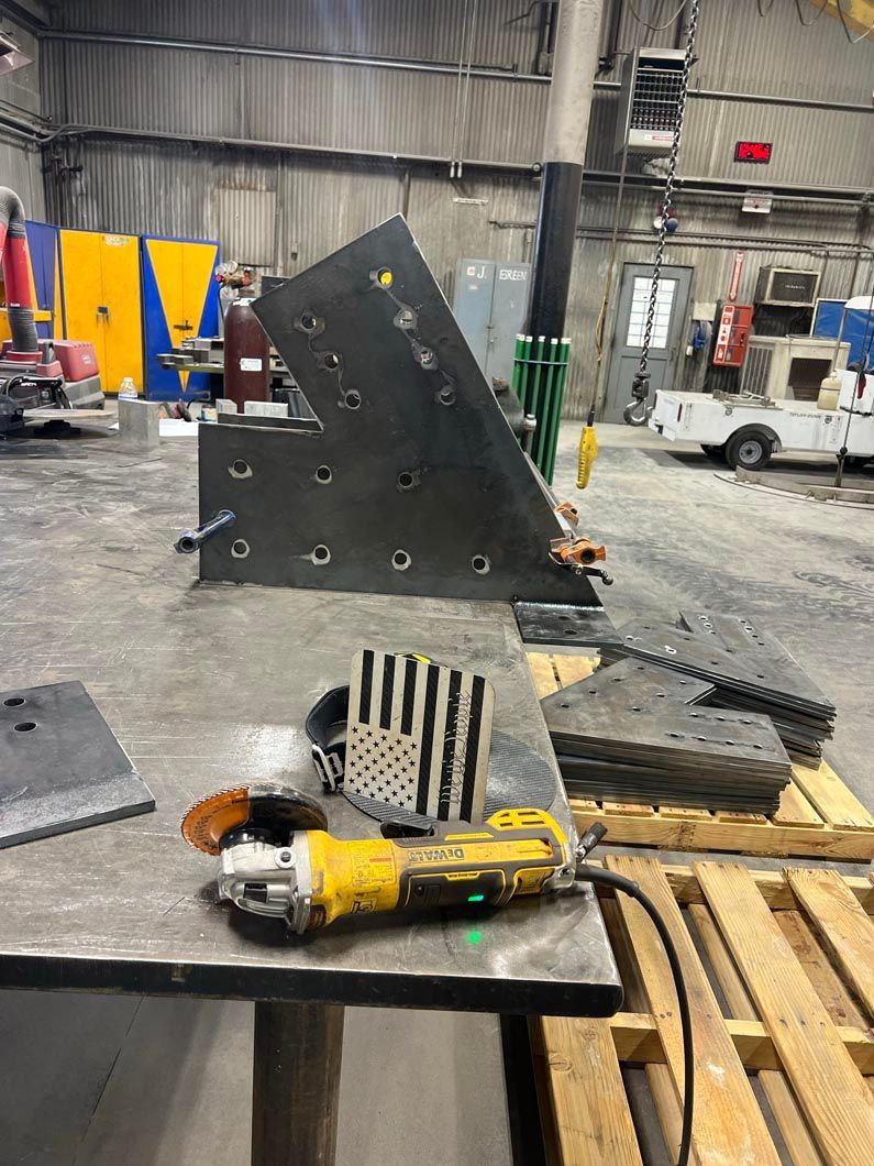 A grinder is sitting on top of a table in a factory.