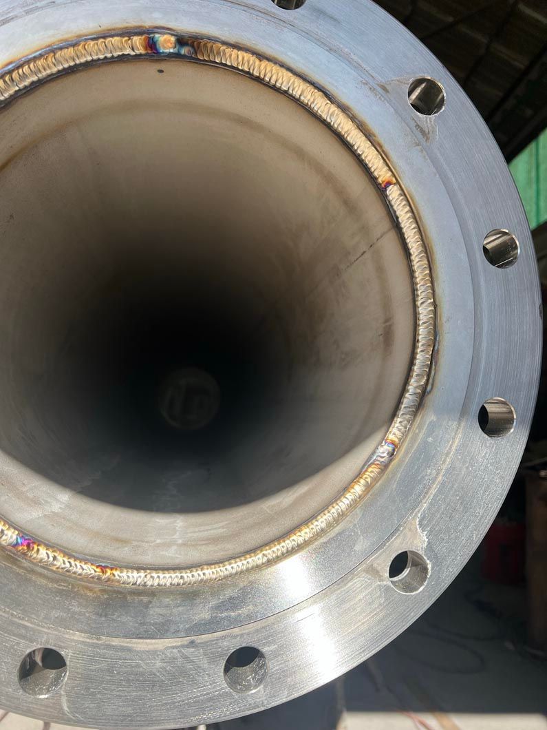 A close up of a metal pipe with a flange on it.