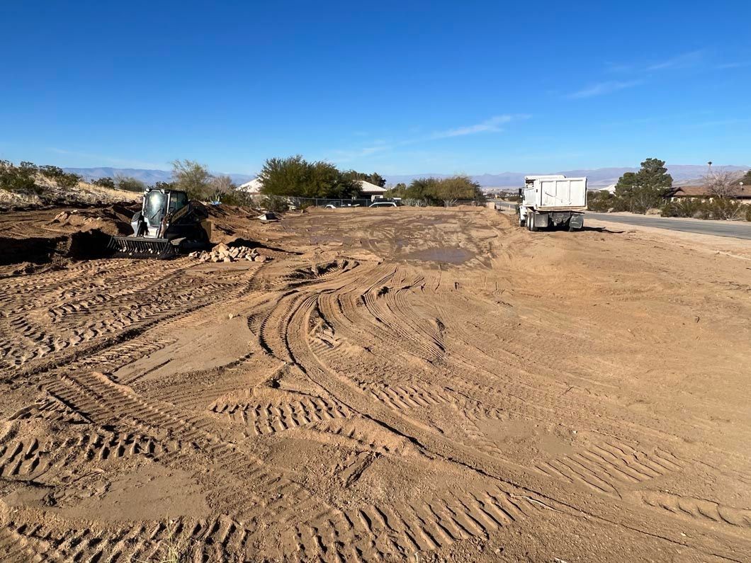 A truck is driving down a dirt road in the desert.
