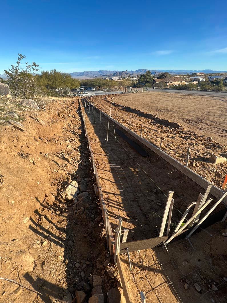 A dirt road is being built in the desert.
