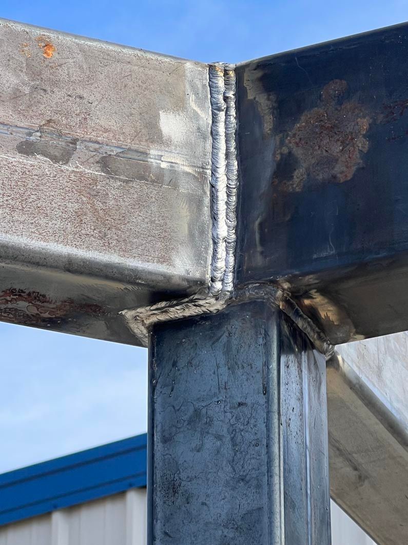 A close up of a metal structure with a blue sky in the background.
